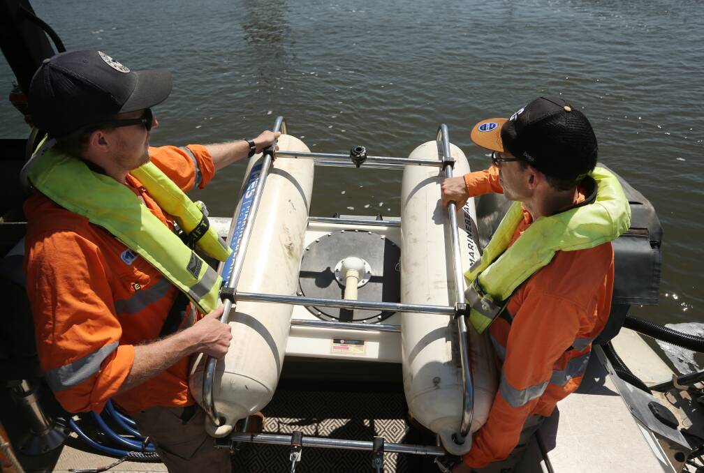 Geophysicists Ryan Frazier and Mark Edmiston with a sub-bottom profiler used during the survey. Picture: Simone De Peak