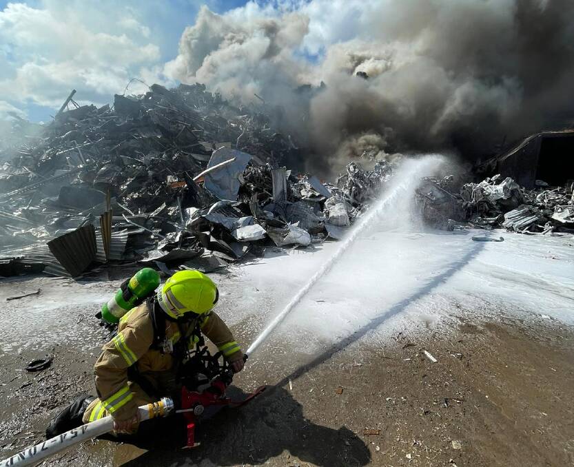 Response: Firefighters were called to Hexham on Sunday after a pile of industrial waste caught alight. Picture: Fire and Rescue NSW