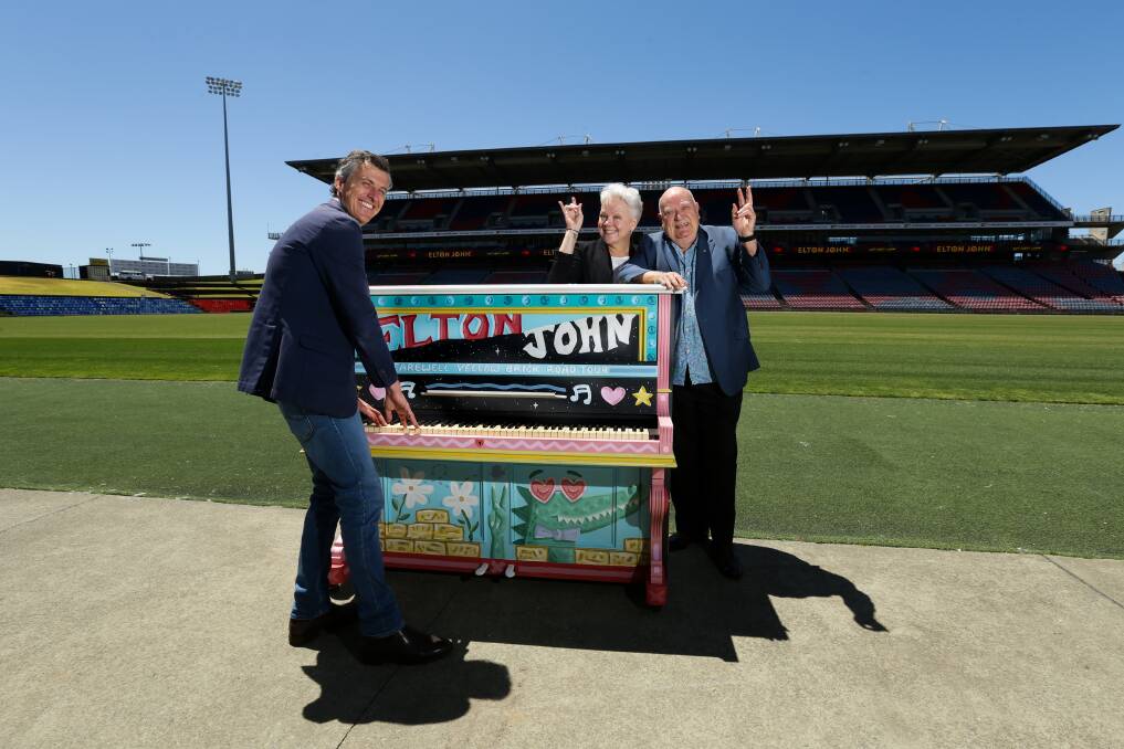 Stephen Saunders, Newcastle councillor Carol Duncan and Michael Chugg with a piano painted by Mitch Revs. Picture by Jonathan Carroll 