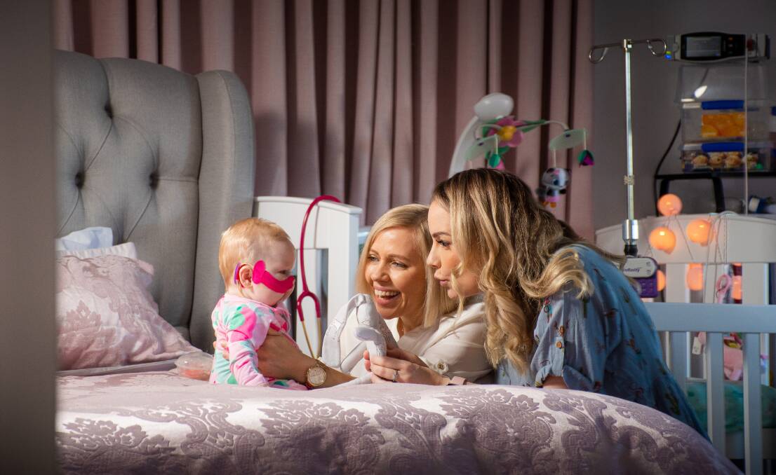 Poppy Grace Middleton with her parents Carly and Tresne at home in Broadmeadow in late 2021. Picture by Simon McCarthy