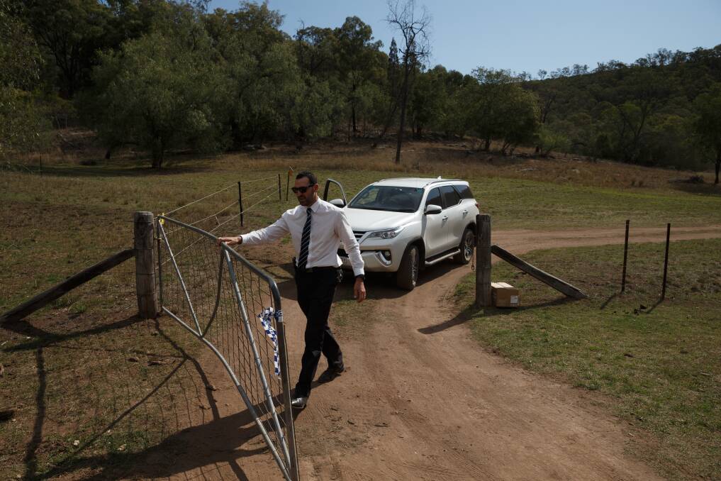 Investigating: A detective at the entrance to the Doyles Creek property, which became a crime scene this week. Picture: Max Mason-Hubers