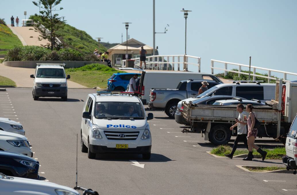 On patrol: Police at the Dixon Park beach carpark on Tuesday. Picture: Max Mason-Hubers