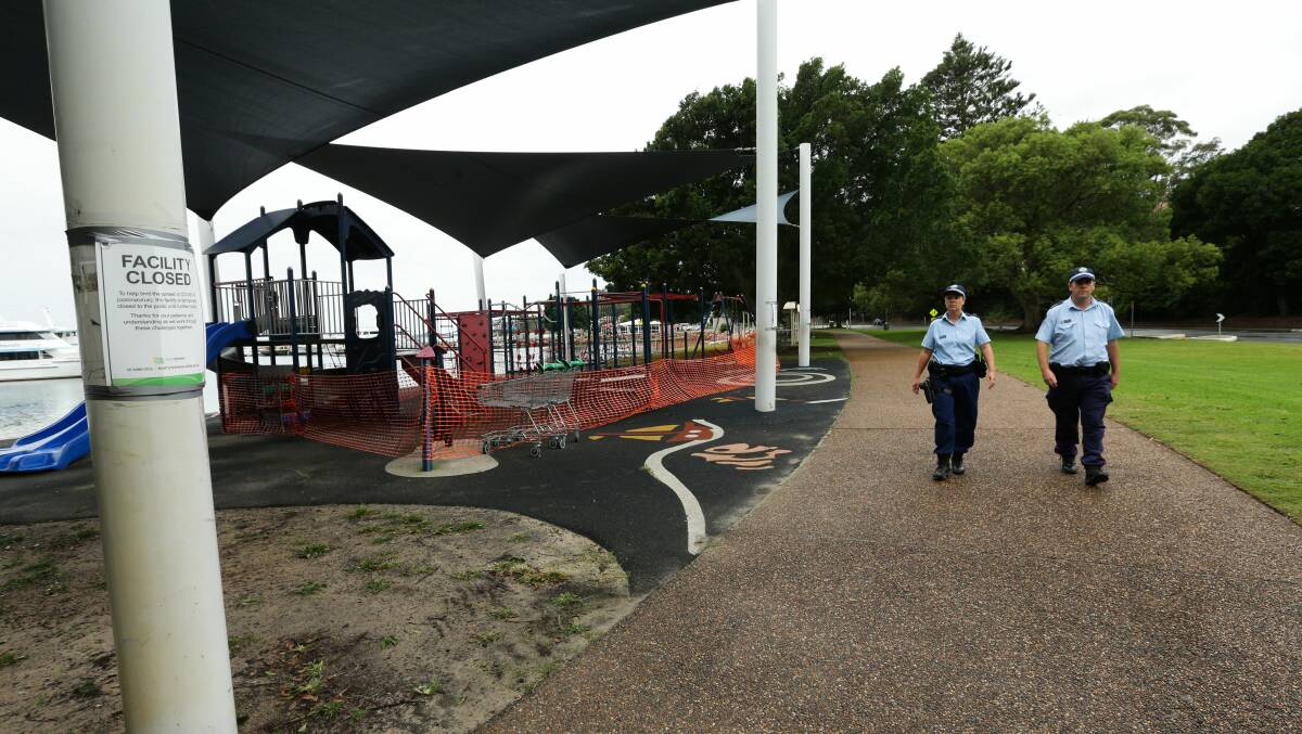 Quiet: Police on duty at Nelson Bay on Friday afternoon. Picture: Jonathan Carroll