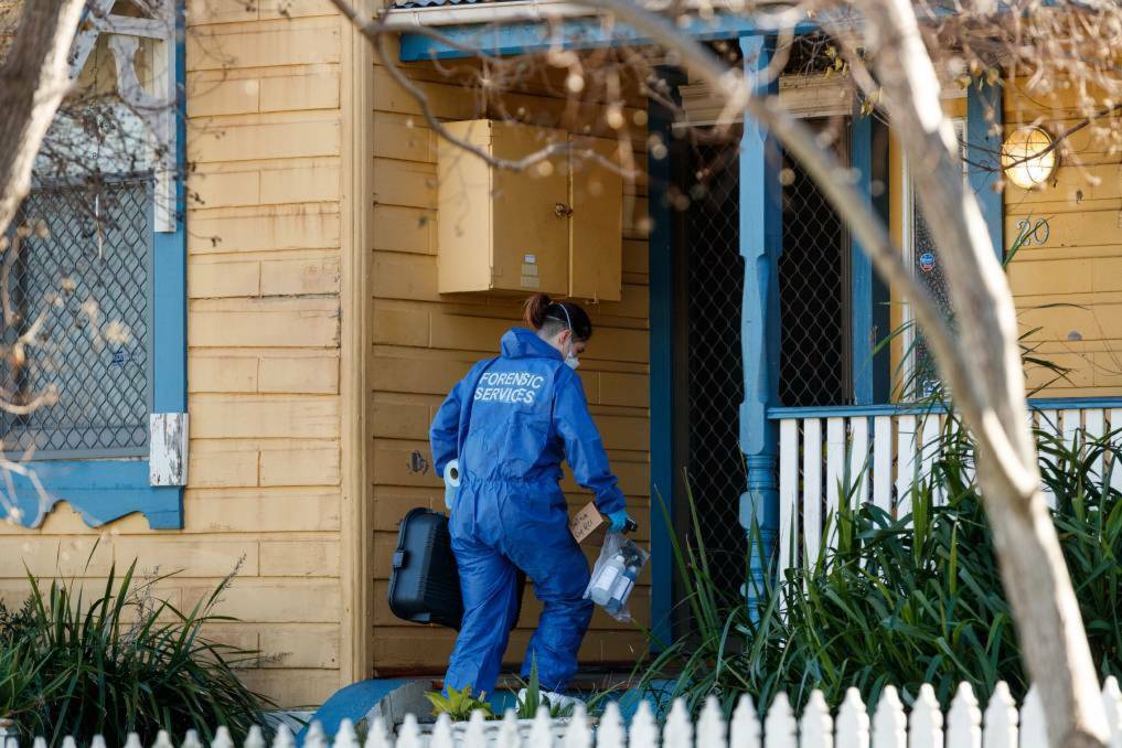 CRIME SCENE: Specialist forensic police examine a boarding house at Mayfield in July after a man's body was found inside.
