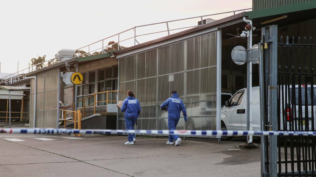 Crime scene officers examining the industrial site at Cardiff where Justin Dilosa was living at the time of his arrest in 2019.
