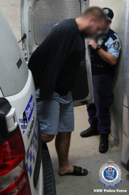 RAID: Kynan Maffesoni, 24, is arrested by Strike Force Pallamana detectives on February 13. Picture: NSW Police 