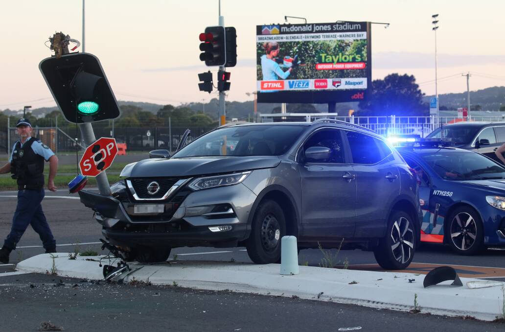 CRASH: Police said the Nissan Qashqai was speeding away from a highway patrol car when the woman crashed into a set of traffic lights. 
