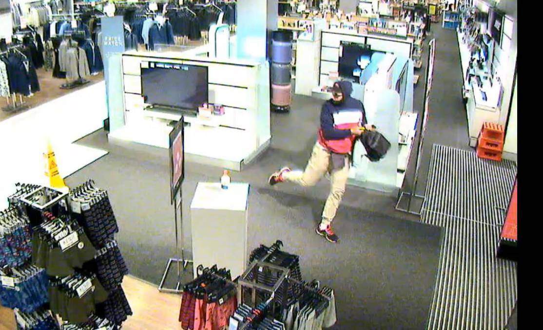 THIEF: CCTV footage shows Gary Anthony Markham fleeing Myer at Charlestown Square after stealing a number of items including Fitbit devices. Markham was found guilty of two robberies after a trial earlier this year and on Friday was jailed for a maximum of nine-and-a-half years. 