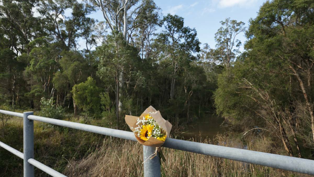 Flowers at Cockle Creek where Ms Easey's body was found. Picture by Simone De Peak
