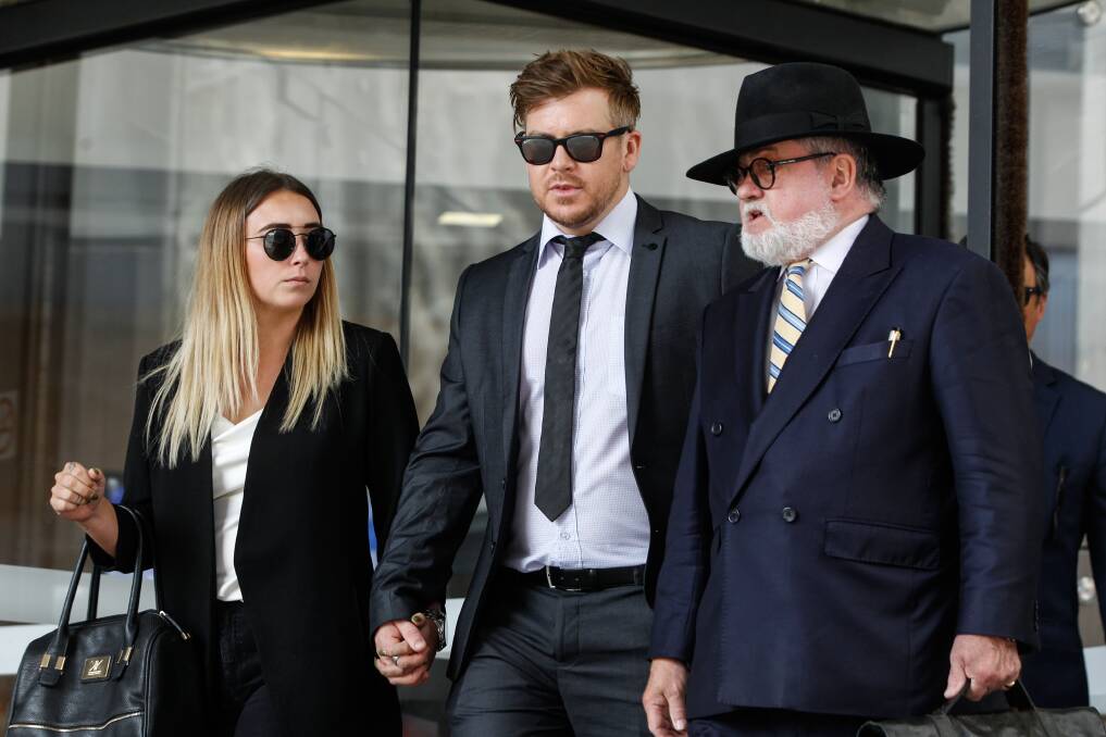 NOT GUILTY: Benjamin Batterham, his partner Monique Cameron and his barrister Winston Terracini are confronted by media outside the Newcastle Supreme Court after Mr Batterham was acquitted of murder over the death of Richard Slater in 2016. Picture: Marina Neil 