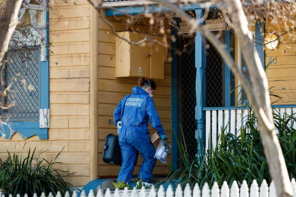 Specialist crime scene police examining the boarding house in Mayfield after the discovery of Mr O'Sullivan's body. Picture by Max Mason-Hubers
