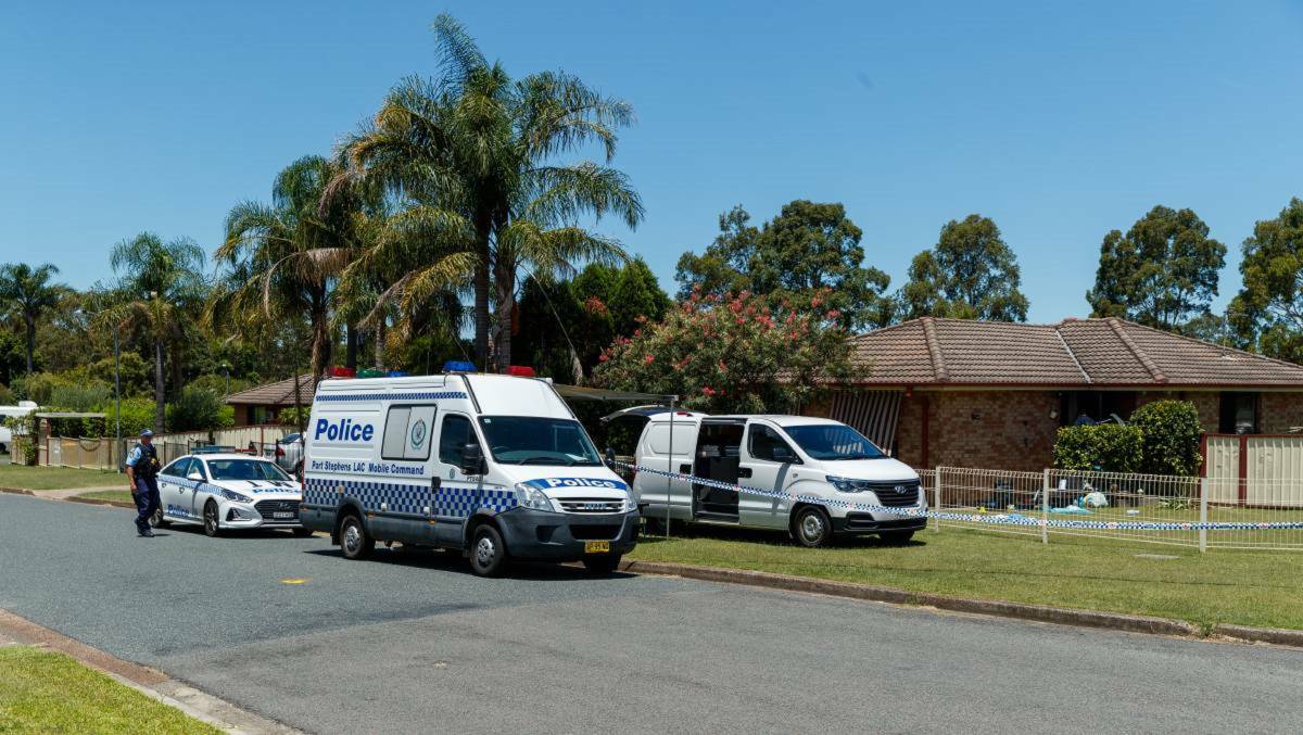 Specialist crime scene police examine the house in Ronald Street at Tenambit where Michael Carroll died in January 2021. Picture by Max Mason-Hubers
