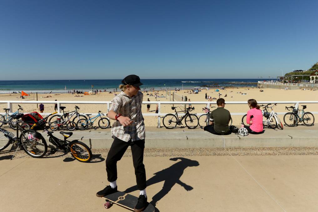 SKATE: Nobbys Beach was a popular spot for people on bikes, skateboards as well as swimmers and surfers on Sunday. Picture: Jonathan Carroll 