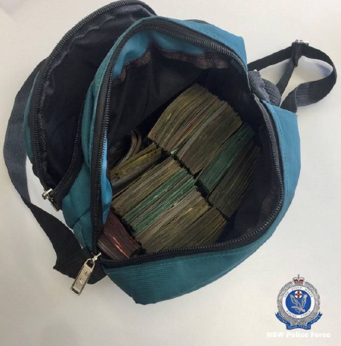 HAUL: The neatly stacked cash, more than $82,000 in all, found in James Francer's backpack when he was arrested in Newcastle in February, 2020. 