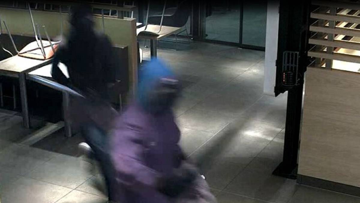 GRAINY: Security vision shows two of the armed robbers who held up the McDonald's restaurant at Williamtown armed with guns and baseball bats on January 25. 