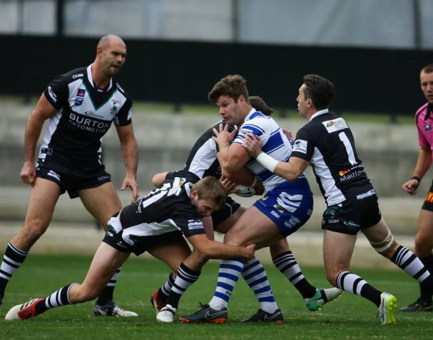 DEFENCE: Cordner, in blue and white, playing for Central Newcastle in the Newcastle Rugby League competition. 