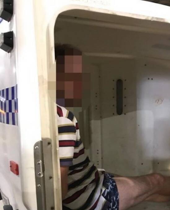 CAUGHT: James Geoffrey Tozer in the back of a police caged truck after his arrest at Kotara on Thursday. Picture: NSW Police 