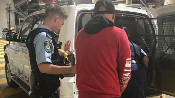 STRIKE FORCE: One of the two men is arrested in the underground carpark at Westfield Kotara in March last year. Picture: NSW Police
