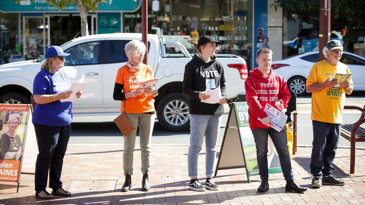 COLOURS OF THE CAMPAIGN: Candidates and volunteers handing out how to vote cards this week in the seat of Indi formerly held by independent Cathy McGowan.