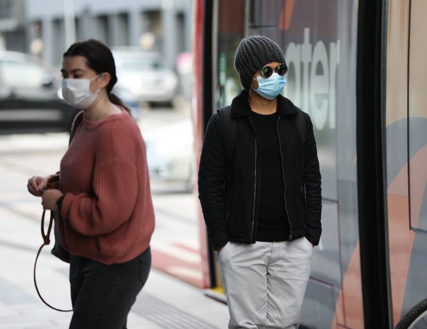 CAUTION: Tram passengers wearing masks at Newcastle Interchange earlier this week. Pictures: Jonathan Carroll