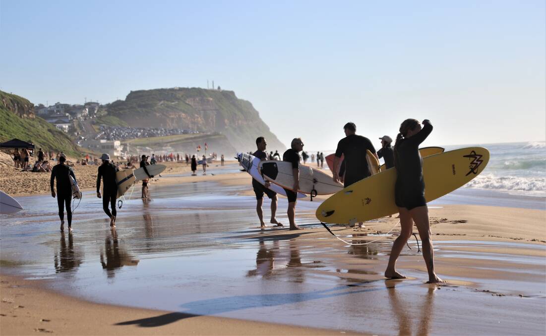 EVERYBODY OUT: Shocked surfers stand on the beach on Tuesday morning after a shark was spotted at Dixon Park. Picture: Dave Anderson