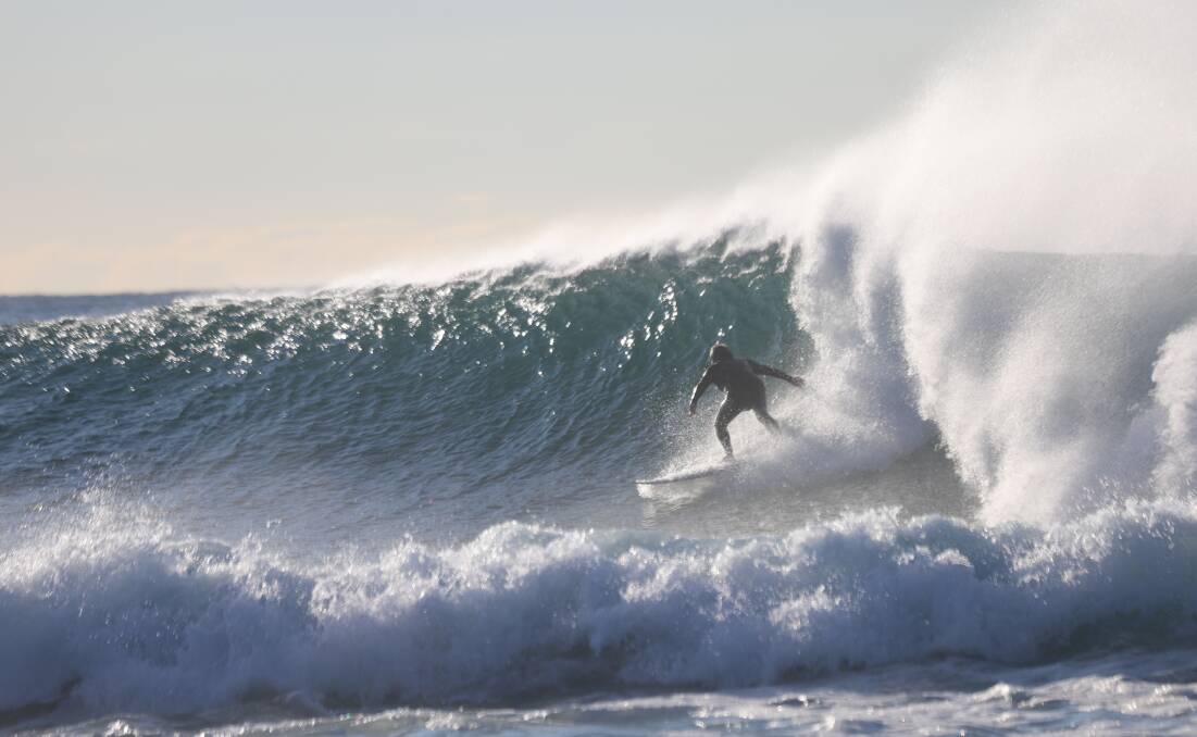 WAVES: A surfer tackles Merewether on Sunday. Picture: Dave Anderson