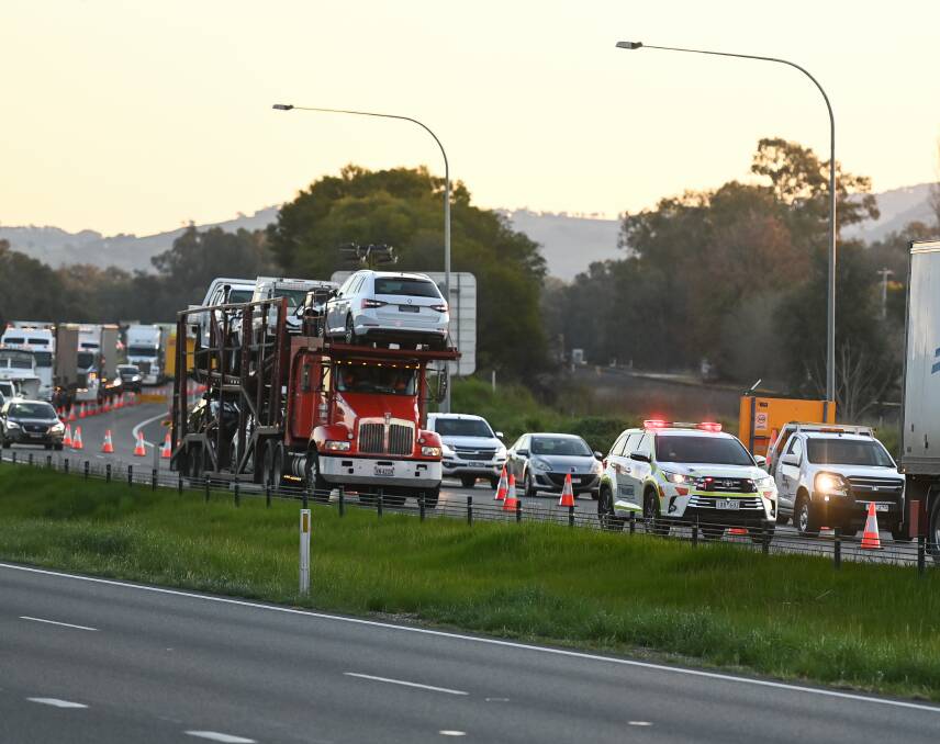 Vehicles approach the Hume Highway checkpoint in Albury. Picture: MARK JESSER