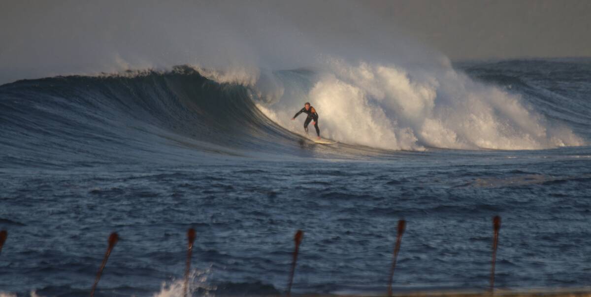A surfer makes the most of yesterday's conditions. Picture: Dave Anderson