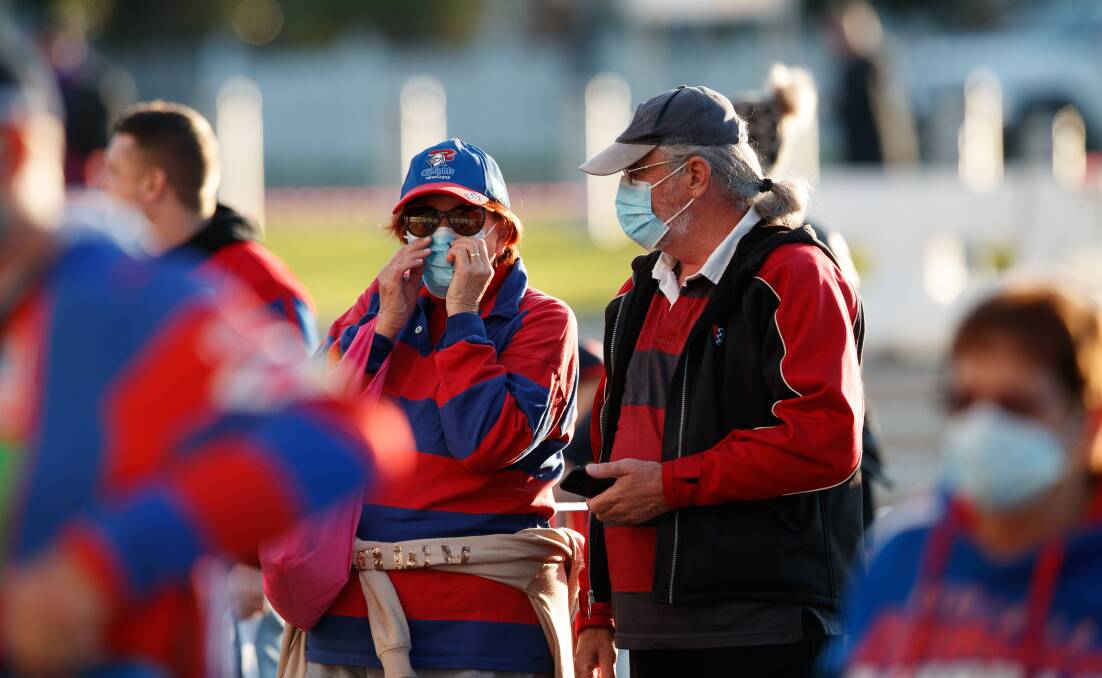 COVERED UP: Rugby league fans donned masks at McDonald Jones Stadium on Saturday for the Knights' clash with the Wests Tigers. Picture: Max Mason-Hubers 