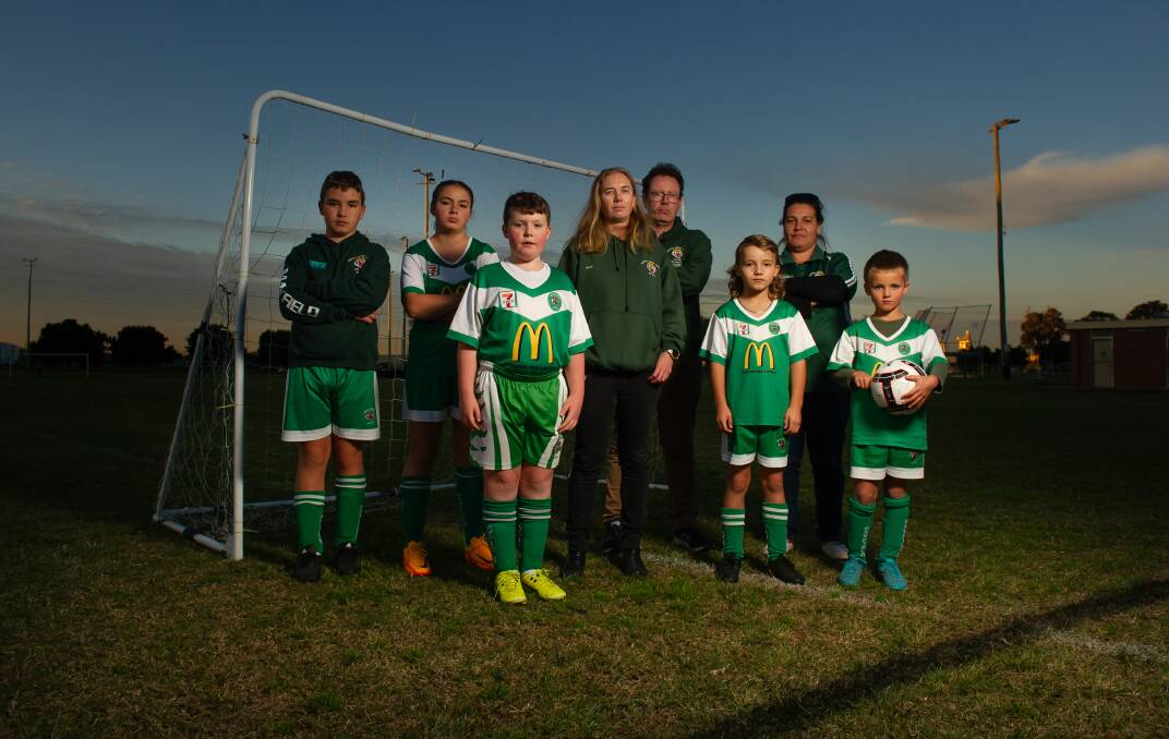 STRETCHED: Mayfield United Junior Soccer Football Club vice president Susan Kay, with players and club representatives. Picture: Marina Neil