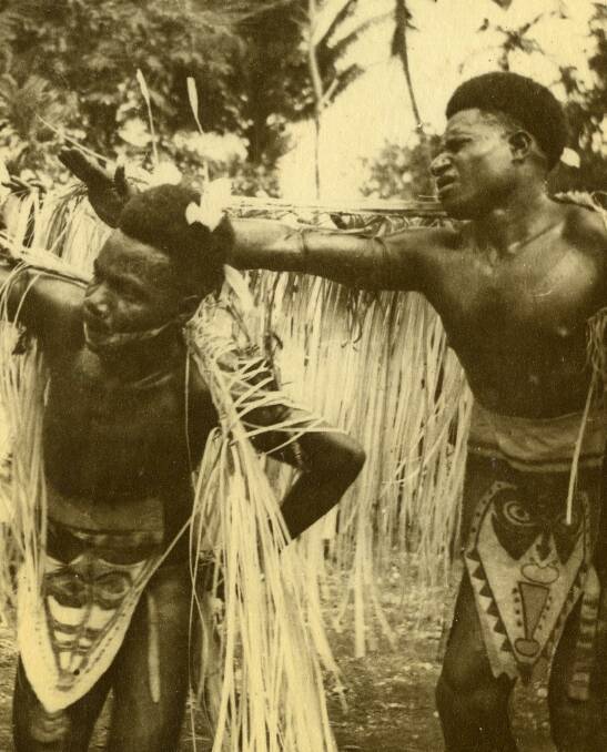 "New Guinea natives perform a traditional dance at a sing-sing. Image courtesy of University of Newcastle's Cultural Collections."