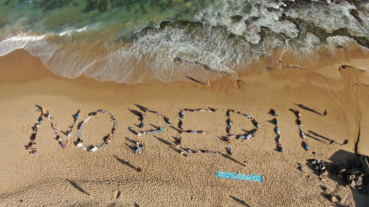 Protesters formed a human chain at Bar Beach last month in opposition to PEP 11. Picture: Hunter Community Environment Centre