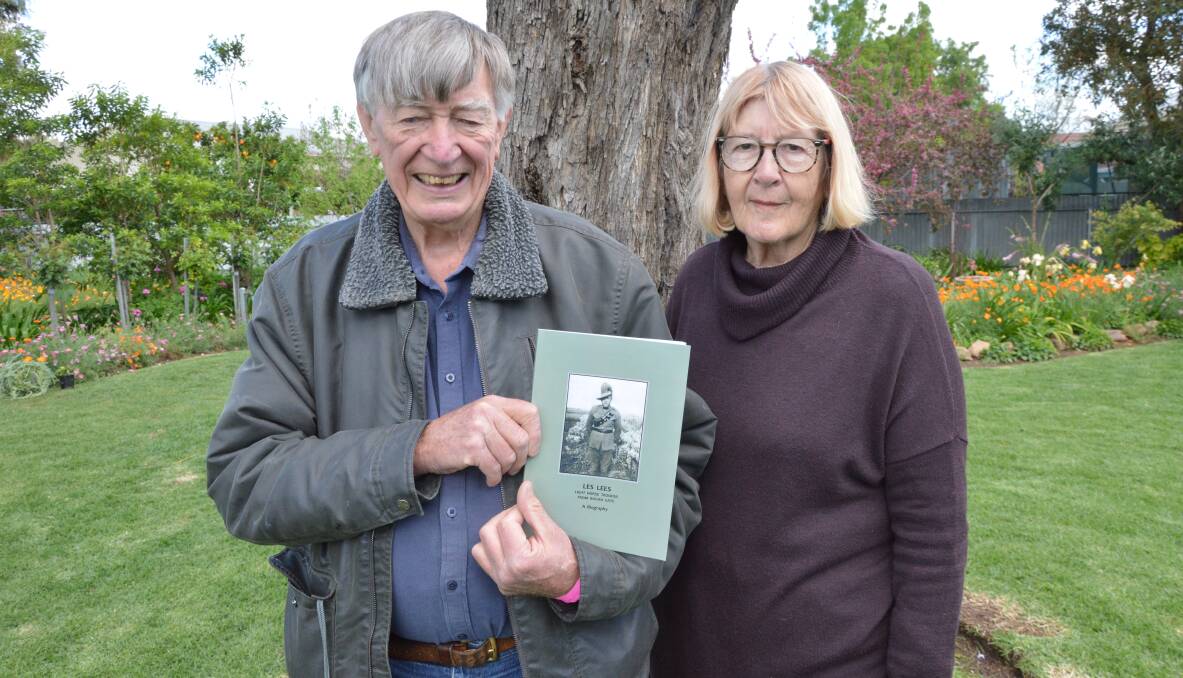 Rex and Heather Veal with the biography of Heather's father Les Lees, a farmer from Bogan Gate, that features his diaries and photographs from World War 2. Picture by Christine Little