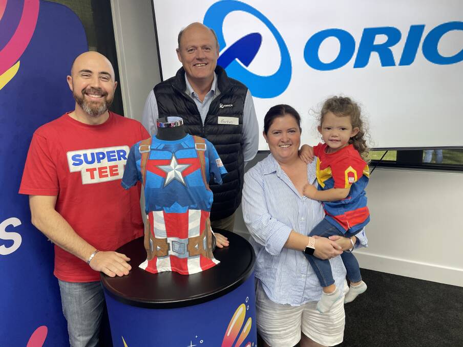 Supertees founder Jason Sotiris, Orica continuous manufacturing vice president Bertus De villiers and Maryland mum Amy Campton with her daughter Amaya Hickson at the Supertee packing day. Picture by Alanna Tomazin