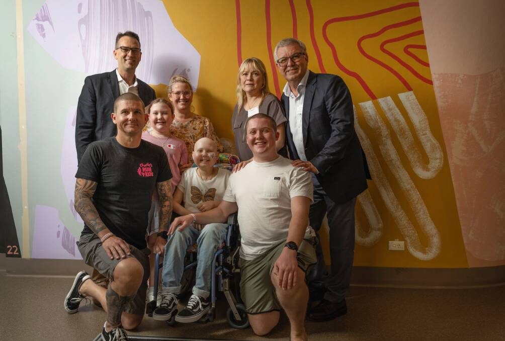 Kids with Cancer Foundation CEO Todd Prees and Dr Frank Alvaro with Emma and her family. Picture by Marina Neil