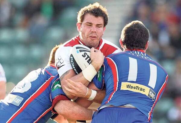 TARGET: Dragons forward Adam Cuthbertson caught in a Knights sandwich. - Picture by Adam McLean