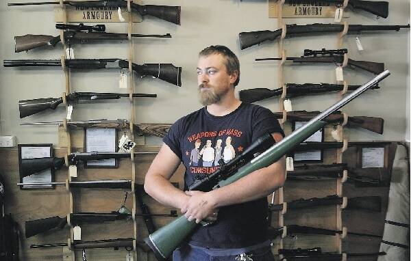 MERIT: Duncan Sinclair, of the New England Armoury store, holds a 6.5mm rifle yesterday.- Picture by Peter Stoop