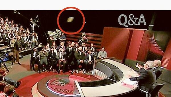 INCIDENT: A shoe (circled) being thrown at Mr Howard.