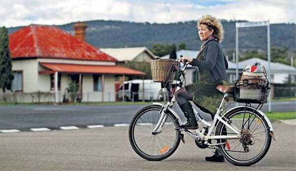 FIGHTER: Sue Abbott on her bike near where she was fined for riding without a helmet. - Picture by Simone De Peak