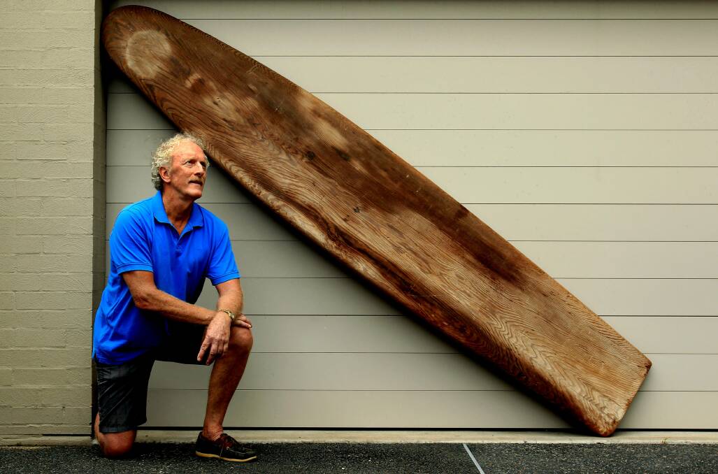 SURF RELIC: Dave Ringland shows off his rare California redwood surfboard, once owned by his father Neil and designed from one made by Hawaii’s Duke Kahanamoku. Picture Simone De Peak 