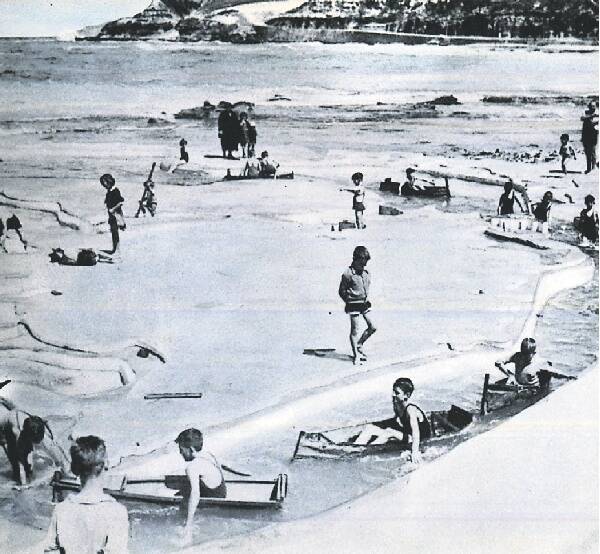 FLASHBACK: Children paddle around a map of the world at the mariner's pool on the rock platform at Newcastle Beach.
