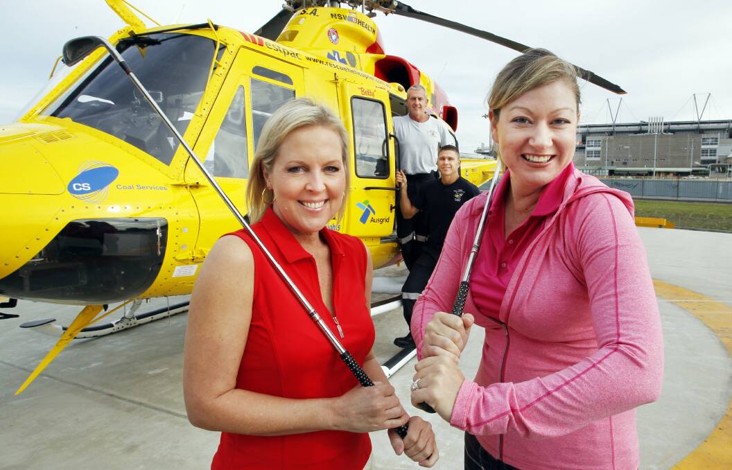 CHARITY: Michelle Faithfull and Melissa Histon-Browning with Westpac helicopter crewmen behind. Picture: Anita Jones