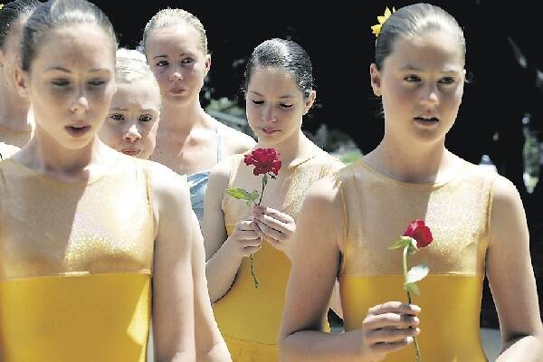 HOMAGE: Mrs Parker's ballet students with roses yesterday. - Picture by Stefan Moore