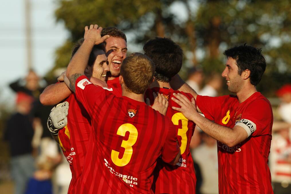 NCH SPORT. NBN State League soccer grand final - Broadmeadow Magic Vs Hamilton Olympic, at Wanderers Oval, Broadmeadow. Pic shows Magic players celebrating their final goal, scored by Rhys Tippett (at back). Sunday 9th September 2012. NCH. Newcastle. Pic MAX MASON-HUBERS MMH