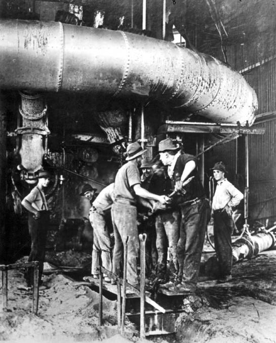 MEN OF STEEL: Newcastle BHP workers open No.1 blast furnace on April 9, 1915 (picture courtesy of BHP archives).