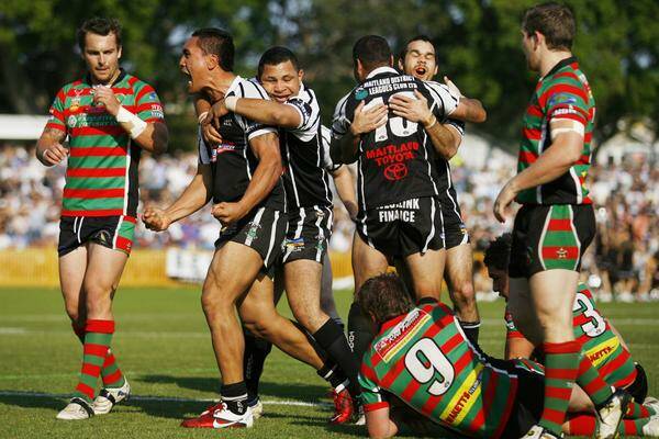 HAPPY TIMES: Vern Moana-Mason, who will miss this season with a knee injury, and Mick Moran, now with Macquarie,    celebrate Maitland’s 2011 grand final victory. Picture: Peter Stoop