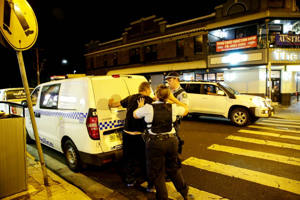 PARTY’S OVER: Police make an arrest in Newcastle’s bar precinct.  Picture: Ryan Osland