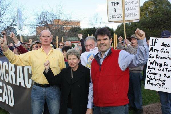 FIERY RALLY: Wyong councillors Greg Best (left) and Doug Eaton with protesters who heard that the cost of homes in the shire would skyrocket as a result of proposed sea level rise measures. 