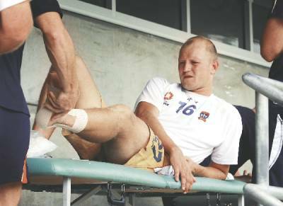 INJURY: Stephen Laybutt receives treatment, above, after rupturing his Achilles tendon at training yesterday.- Pictures by Darren Pateman