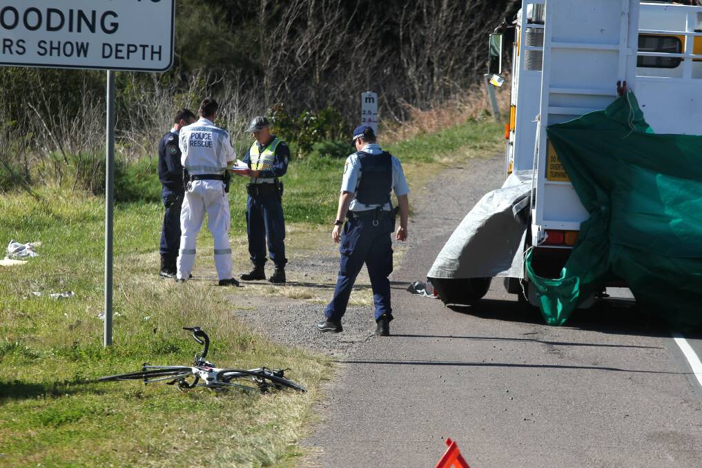 FATAL: Police examine the scene where a cyclist died after he was involved in a collision with a truck at Wallsend yesterday morning. Picture: Phil Hearne